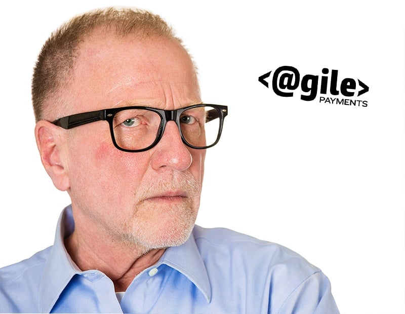 Closeup portrait, senior mature business man in black glasses, suspicious annoyed looking being cautious, careful, thinking, of his own mind, isolated white background. Emotion, facial expression