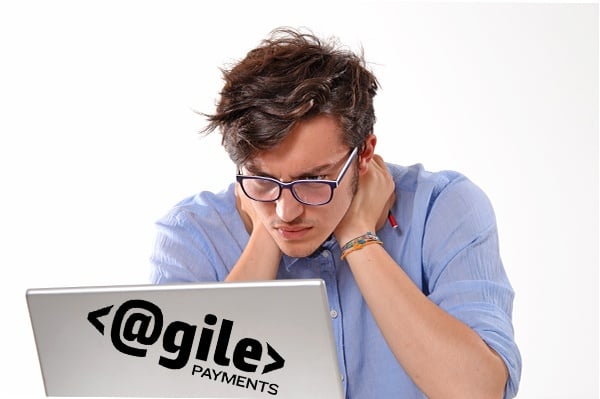 disheveled man looking at computer coming up with solutions for SaaS concerns